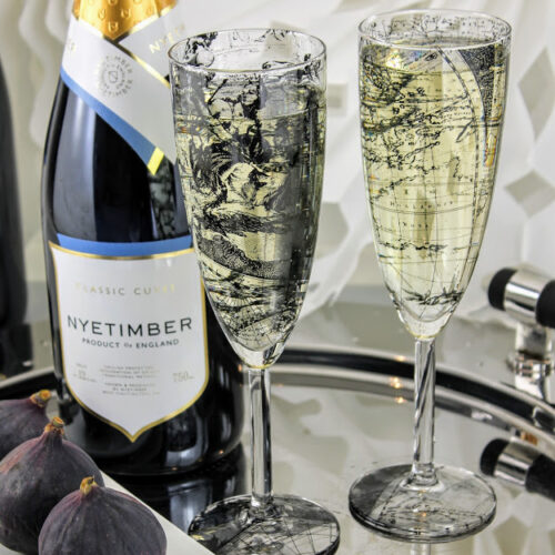 pair of champagne flutes, world map design with figs and Nyetimber English sparking wine