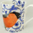 Bone china mug bulfinch in a blue trellis