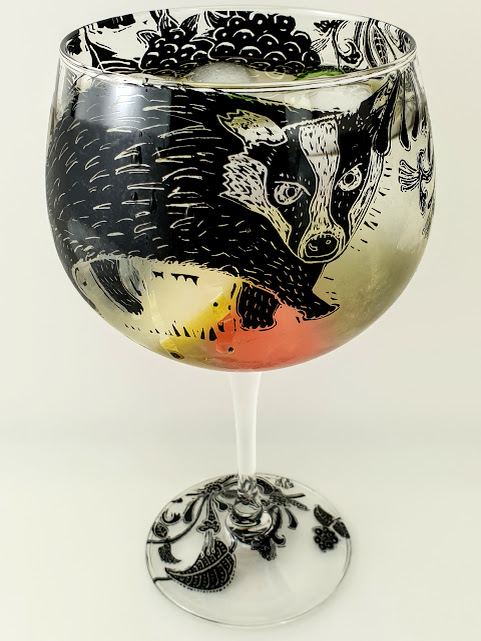 Gin and tonic glass with badgers and blackberrys